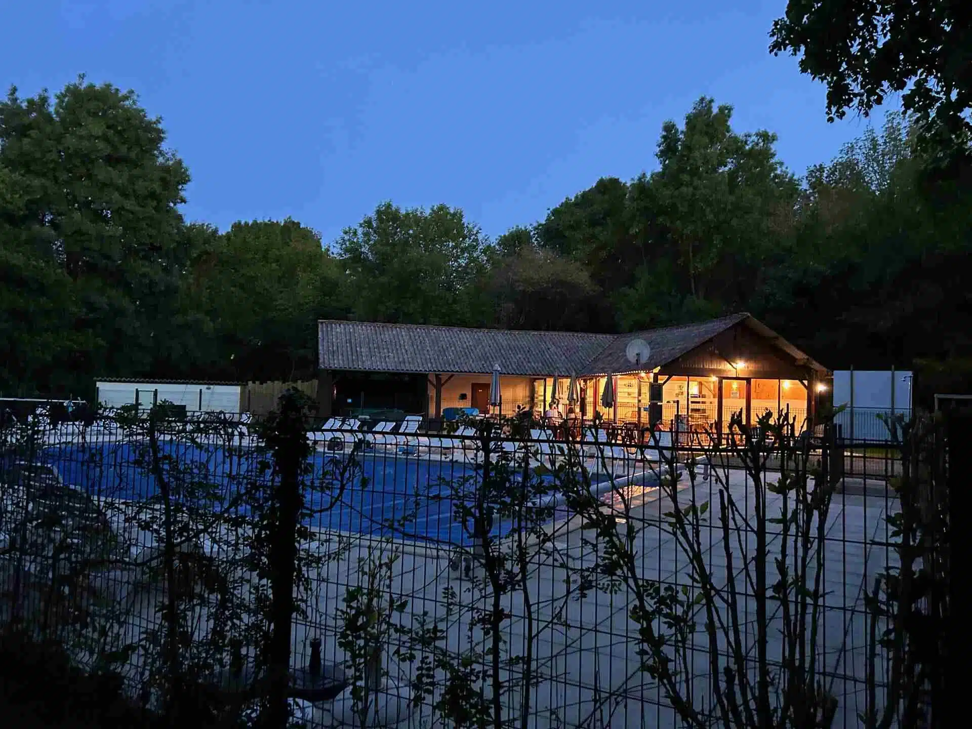 Camping La Vallee des Vignes Bar restaurant and swimming pool by night 1